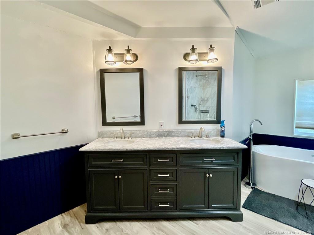 16398 Southwest Two Wood Way Indiantown, FL 34956 - Photo 15 of 24 a bathroom with a sink double vanity and a mirror