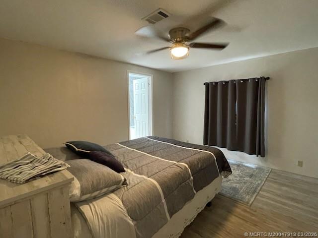 16398 Southwest Two Wood Way Indiantown, FL 34956 - Photo 16 of 24 a bedroom with a bed and a ceiling fan