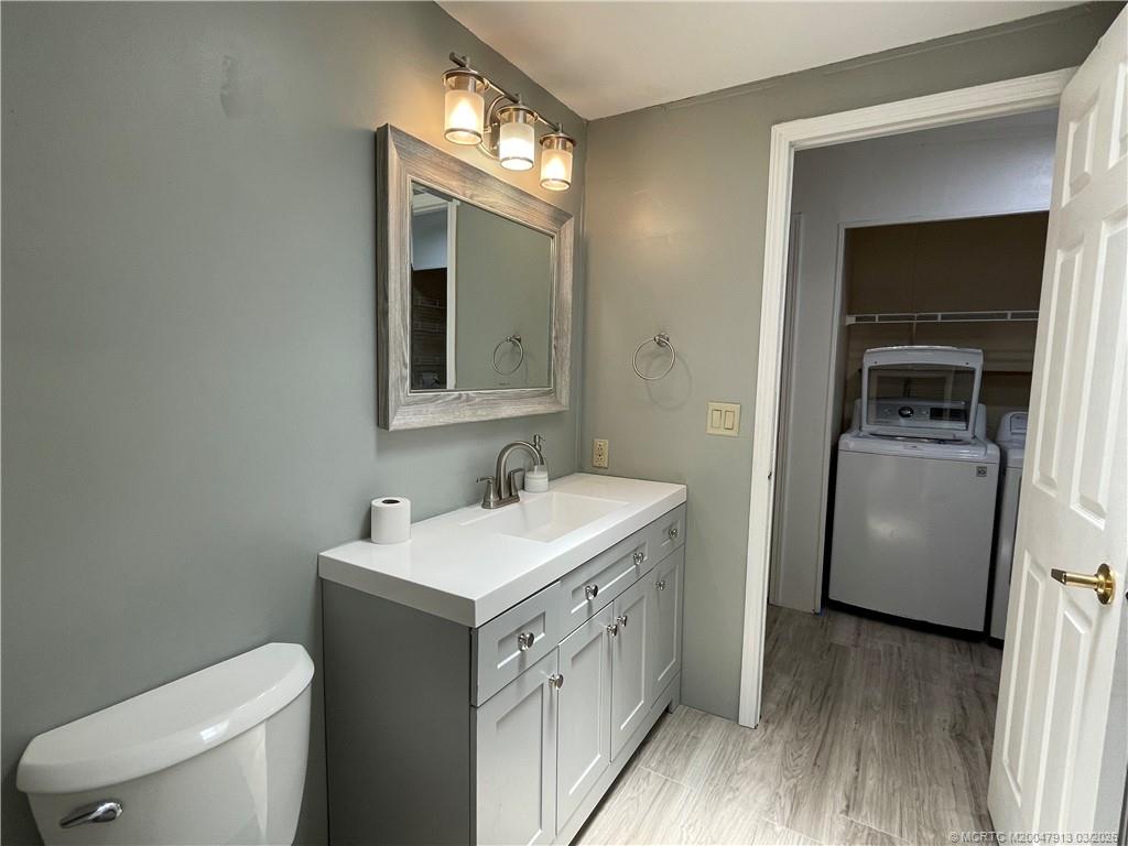 16398 Southwest Two Wood Way Indiantown, FL 34956 - Photo 18 of 24 a bathroom with a toilet sink and mirror