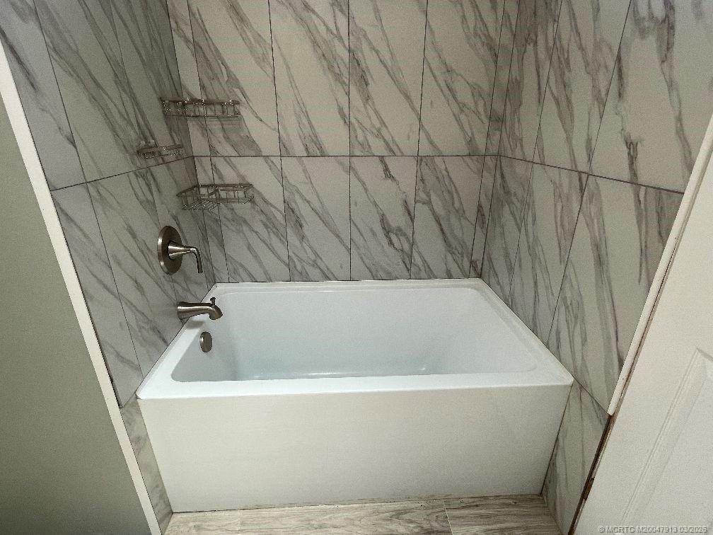 16398 Southwest Two Wood Way Indiantown, FL 34956 - Photo 19 of 24 a bathroom with a bathtub