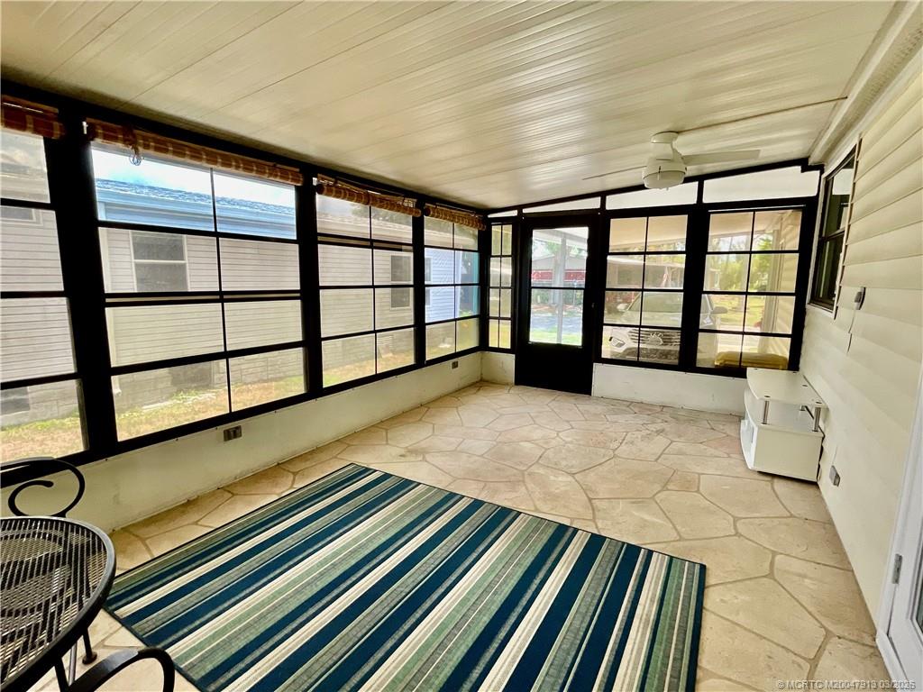16398 Southwest Two Wood Way Indiantown, FL 34956 - Photo 20 of 24 a spacious bedroom with a bed and a large window