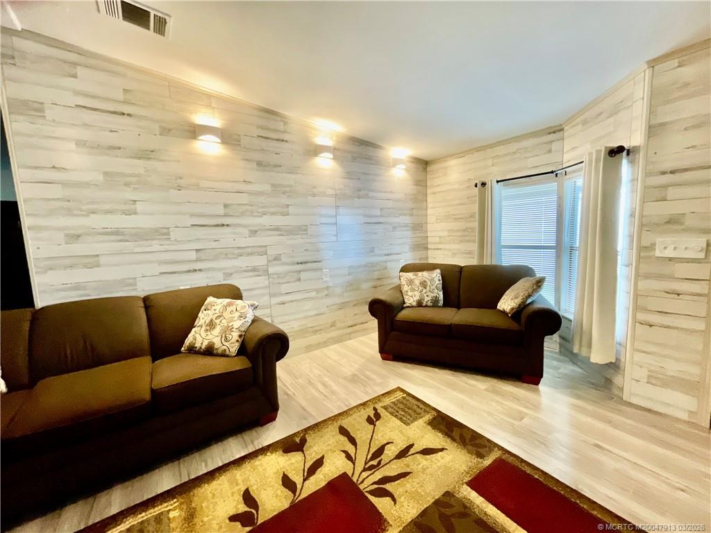 16398 Southwest Two Wood Way Indiantown, FL 34956 - Photo 2 of 24 a living room with furniture and a rug