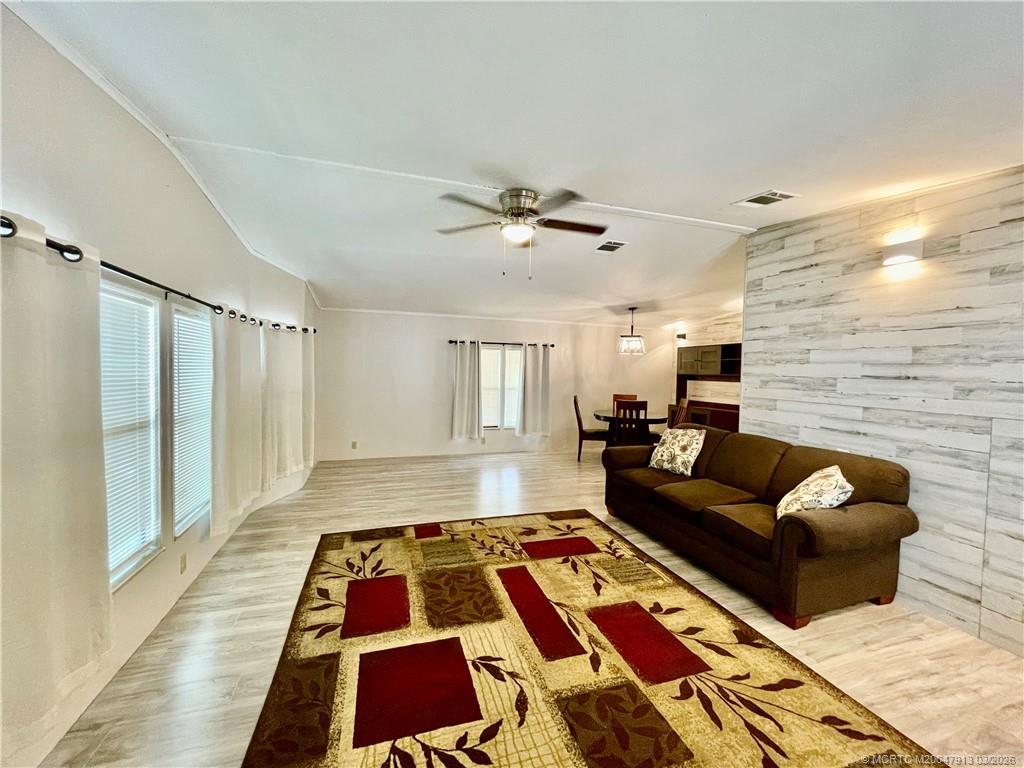 16398 Southwest Two Wood Way Indiantown, FL 34956 - Photo 3 of 24 a living room with furniture and a rug