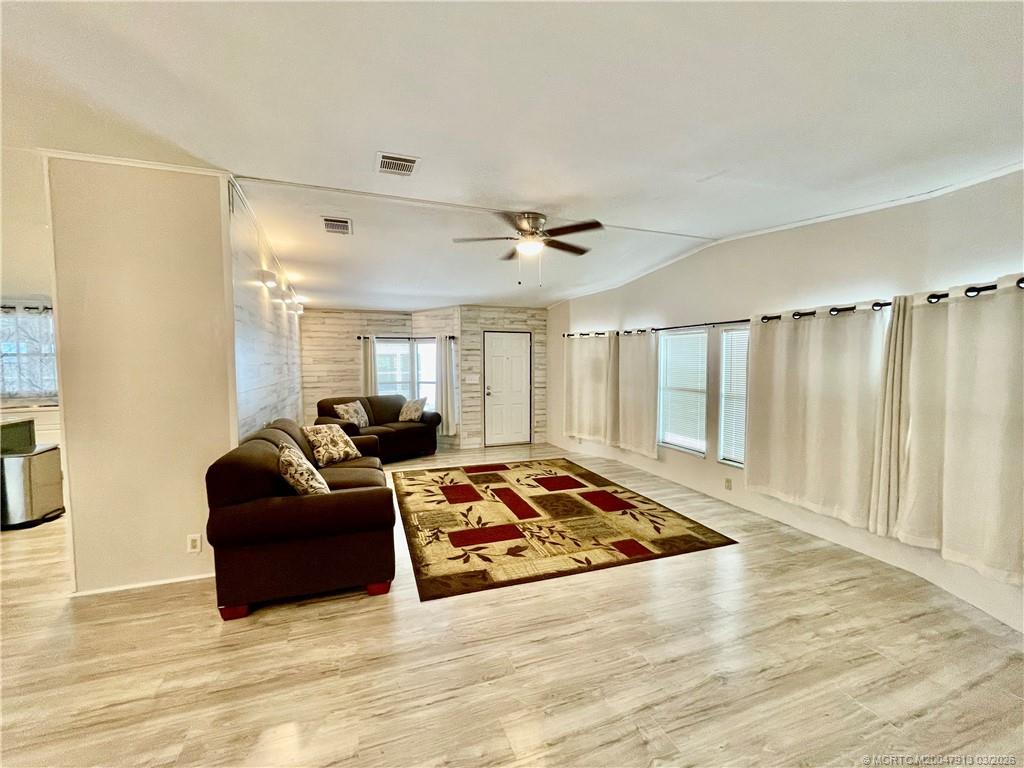 16398 Southwest Two Wood Way Indiantown, FL 34956 - Photo 4 of 24 a living room with furniture and a rug