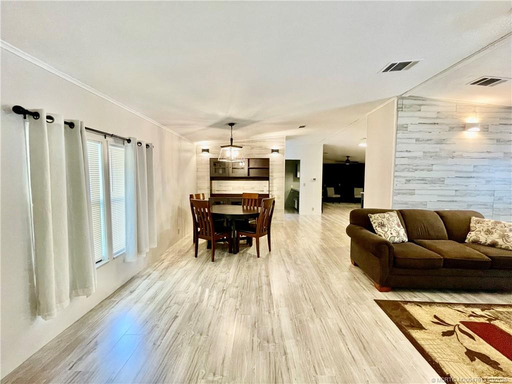 16398 Southwest Two Wood Way Indiantown, FL 34956 - Photo 9 of 24 a living room with furniture and wooden floor