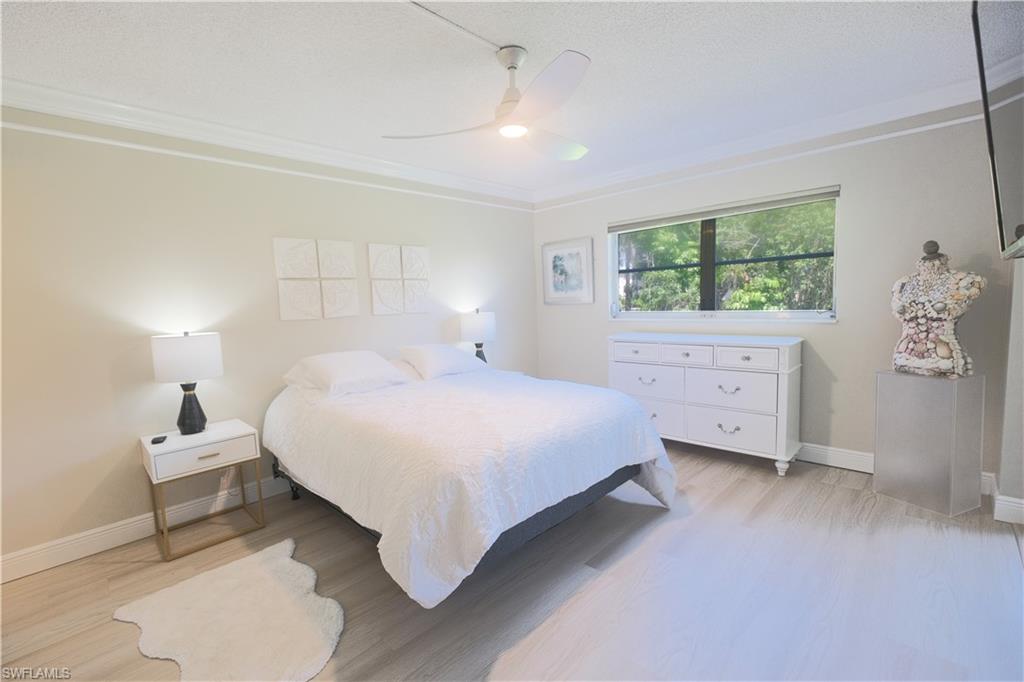 5499 Rattlesnake Hammock Road, Unit A105 Naples, FL 34113 - Photo 12 of 23 Bedroom with ceiling fan, light hardwood / wood-style floors, and crown molding