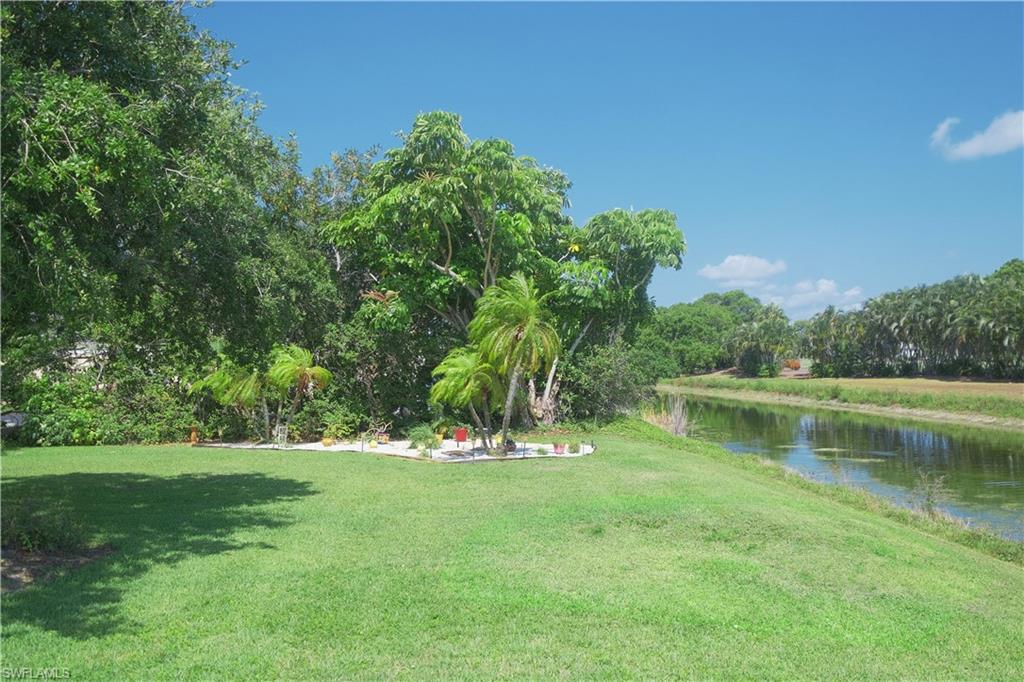 5499 Rattlesnake Hammock Road, Unit A105 Naples, FL 34113 - Photo 21 of 23 View of yard featuring a water view
