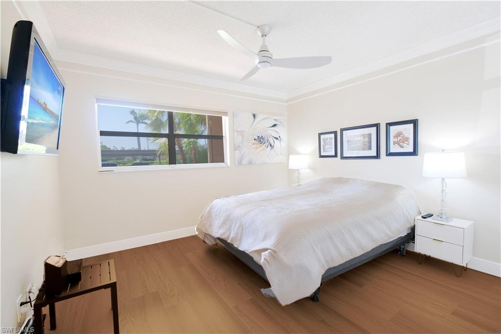 5499 Rattlesnake Hammock Road, Unit A105 Naples, FL 34113 - Photo 4 of 23 Bedroom with wood-type flooring and ceiling fan