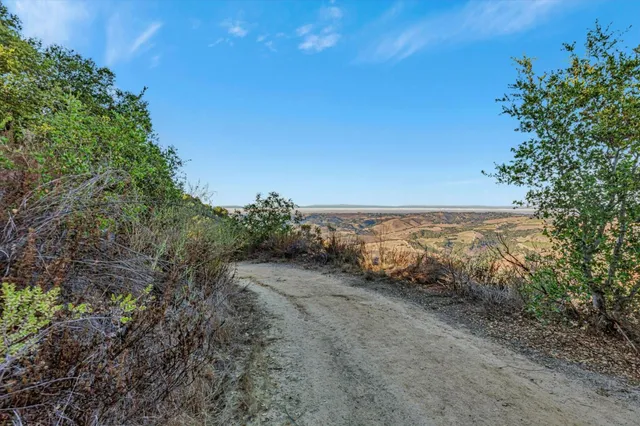 a view of a large mountain with mountains in the background