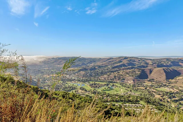 a view of a large mountain with mountains in the background