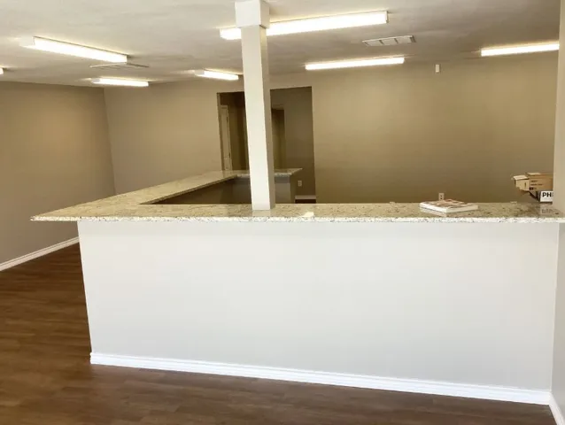 a view of a room with wooden floor and window