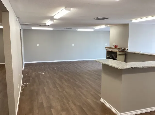 a view of a kitchen with a sink and large window