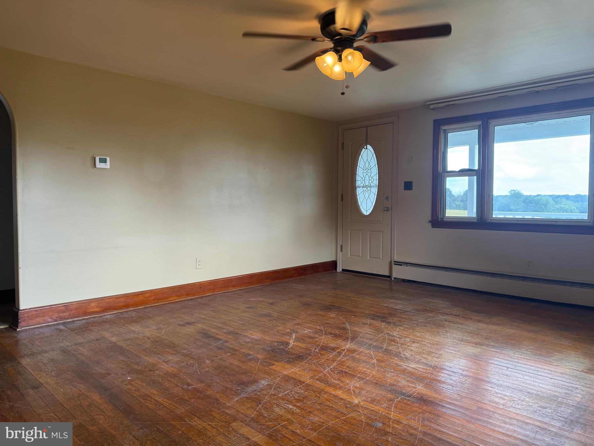 21626 New Freedom Road Freeland, MD 21053 - Photo 5 of 10 an empty room with windows and fan