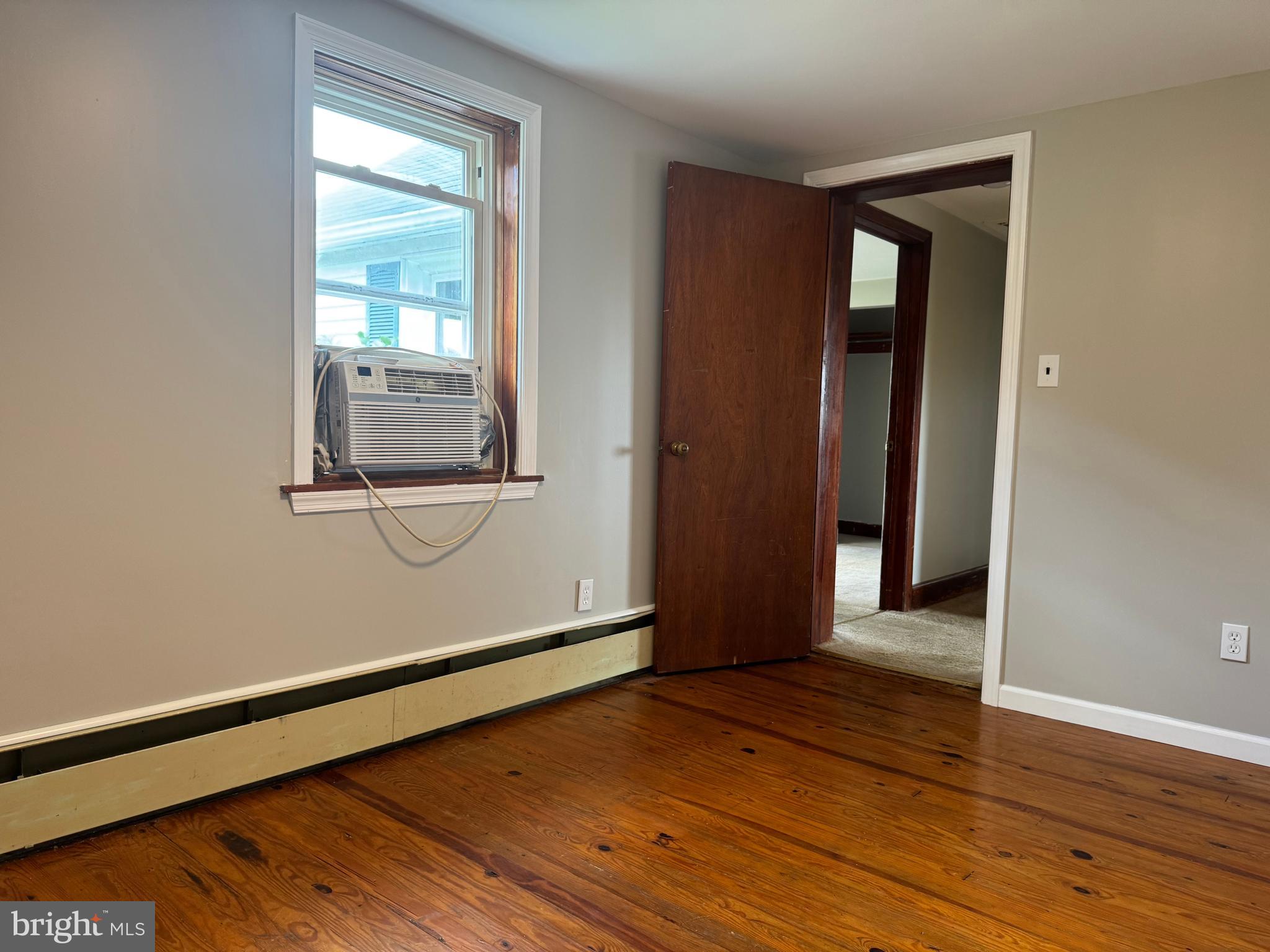 21626 New Freedom Road Freeland, MD 21053 - Photo 7 of 10 a view of an empty room with wooden floor and a window