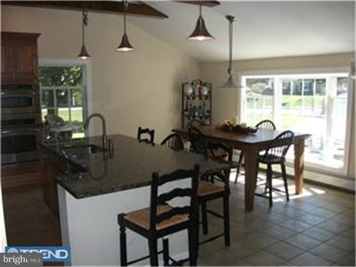417 Suffolk Road Flourtown, PA 19031 - Photo 3 of 12 a kitchen with a table chairs and chandelier