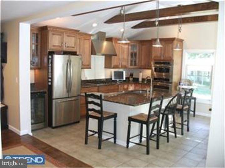 417 Suffolk Road Flourtown, PA 19031 - Photo 4 of 12 a kitchen with stainless steel appliances kitchen island granite countertop a refrigerator and microwave