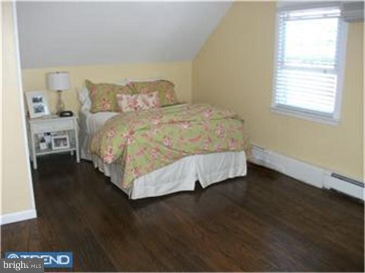 417 Suffolk Road Flourtown, PA 19031 - Photo 7 of 12 a bed sitting in a bedroom next to a window