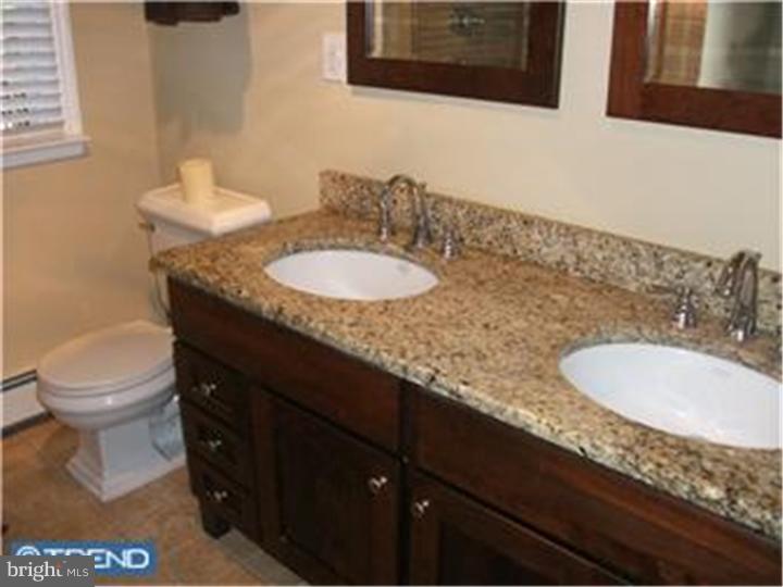 417 Suffolk Road Flourtown, PA 19031 - Photo 9 of 12 a bathroom with a granite countertop sink and a mirror