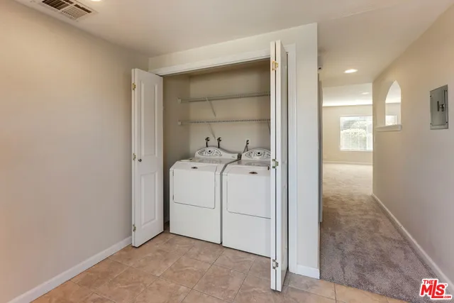 a view of a storage & utility room with washer and dryer