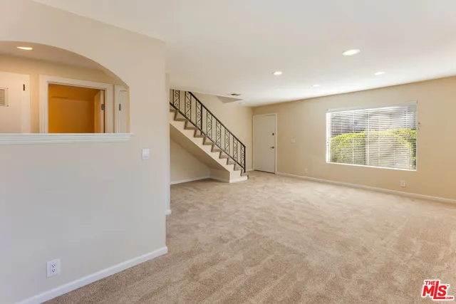 a view of an empty room with stairs
