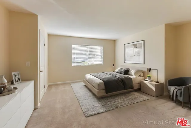 a spacious bedroom with a bed and a couch