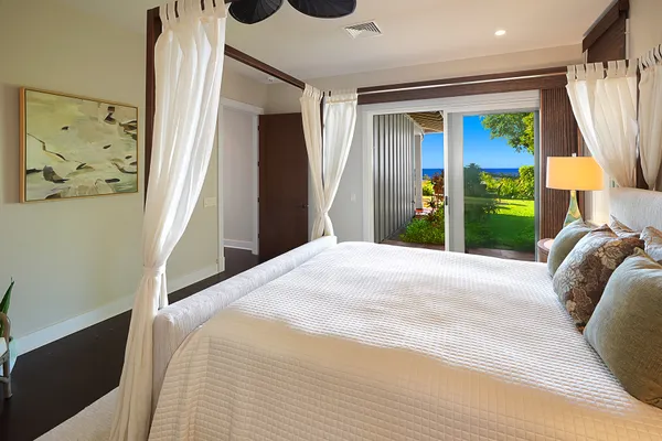 a bedroom with a bed and a painting on the wall