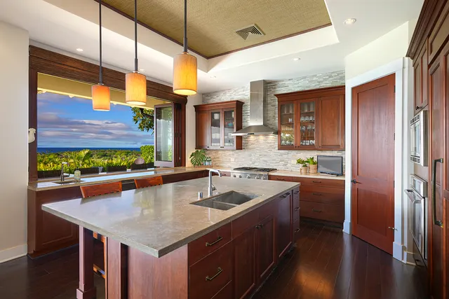 a kitchen with stainless steel appliances granite countertop a sink a stove and a refrigerator