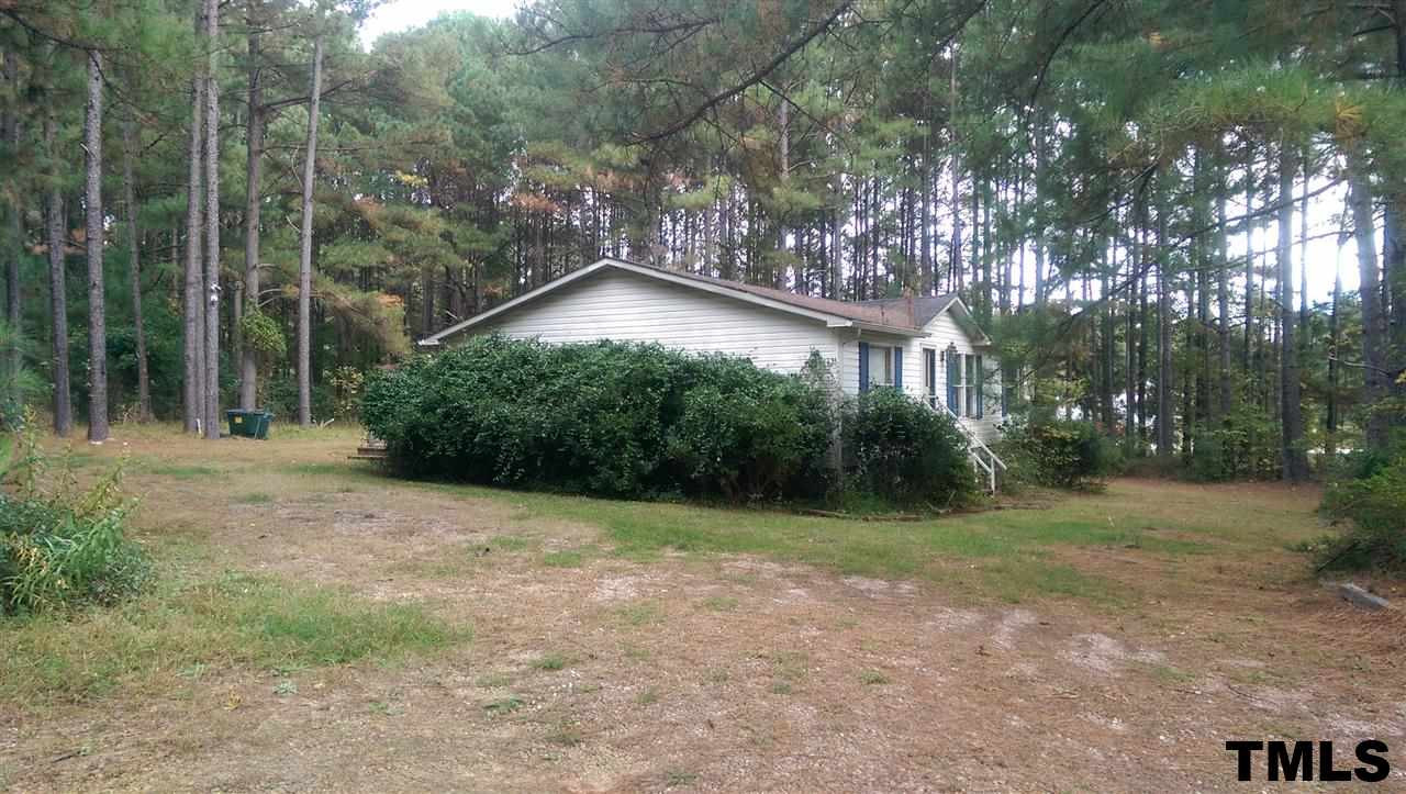 6633 Riley Hill Road Wendell, NC 27591 - Photo 5 of 5 a view of a house with a yard and large trees
