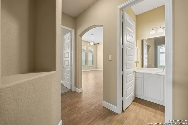 a view of a hallway with wooden floor and closet
