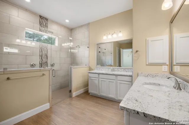 a bathroom with a granite countertop sink mirror and a