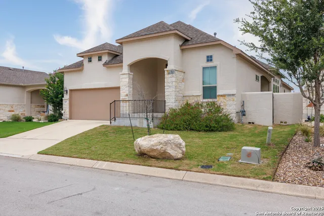 a front view of a house with a yard garage and outdoor seating