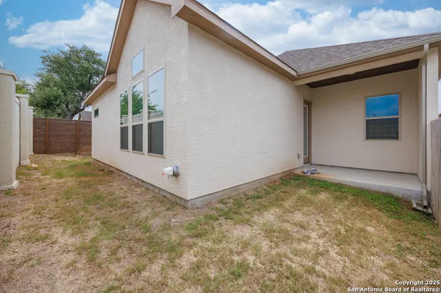 a view of a house with backyard and deck