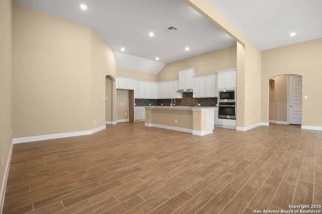 a view of a kitchen with a sink and a refrigerator