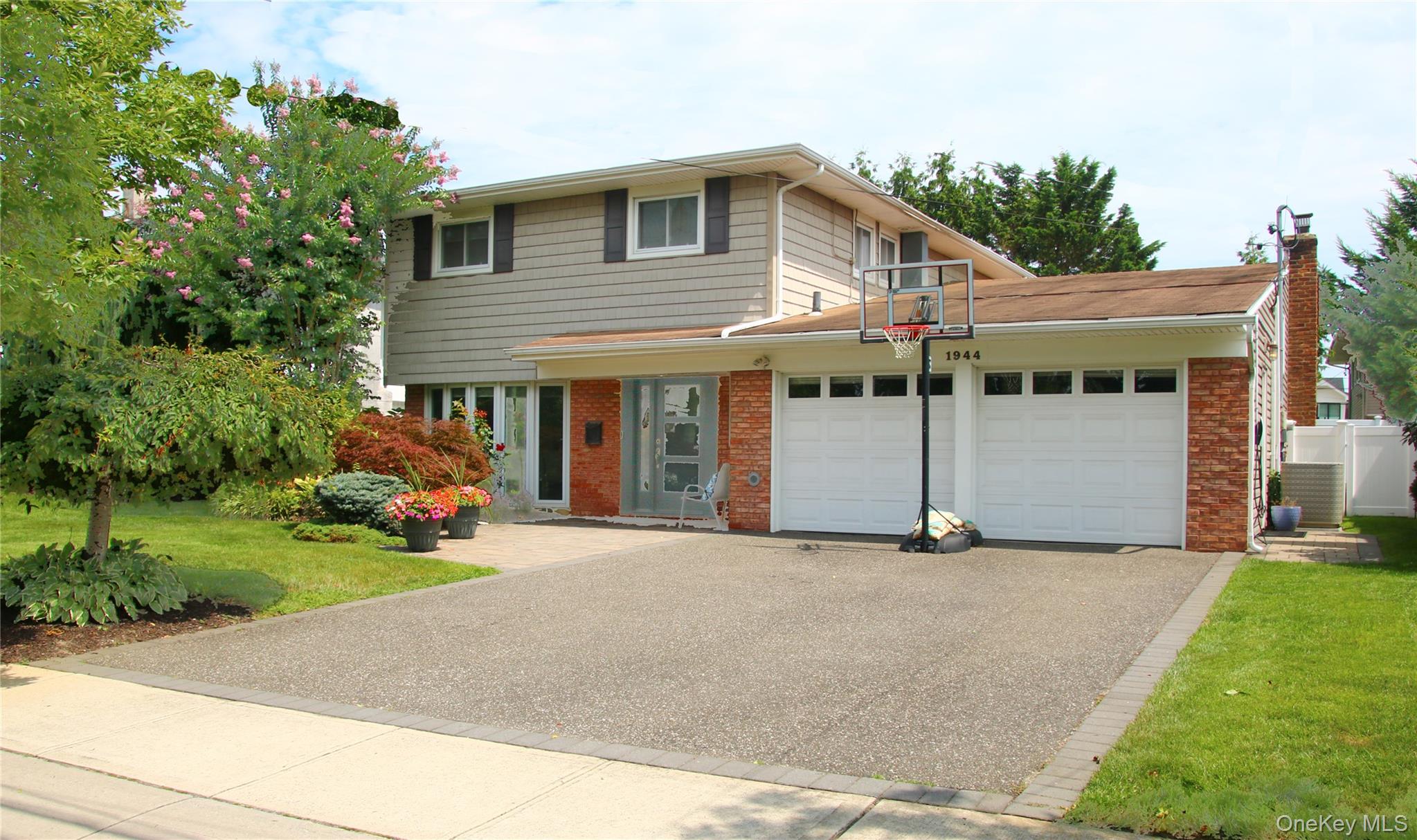 1944 Lowell Lane Merrick, NY 11566 - Photo 1 of 1 a front view of a house with a yard and potted plants