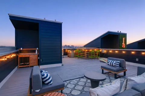 a view of a porch with furniture and a fire pit