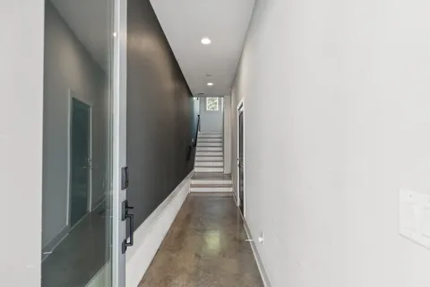 a view of a hallway with wooden floor