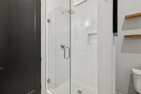 a bathroom with a shower and toilet