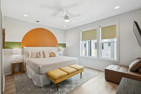 a bedroom with a bed and a flat screen tv