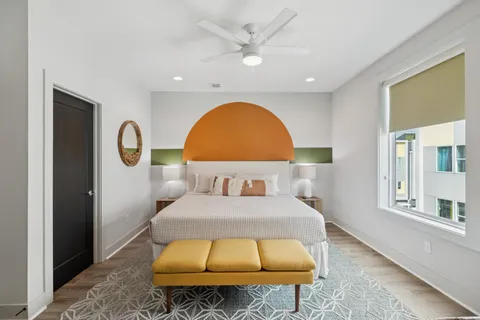 a bedroom with a bed and a flat screen tv