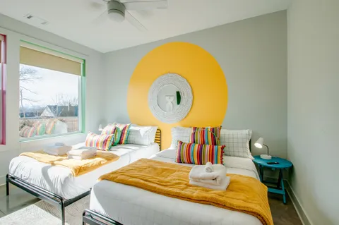 a bedroom with two beds and a flat screen tv
