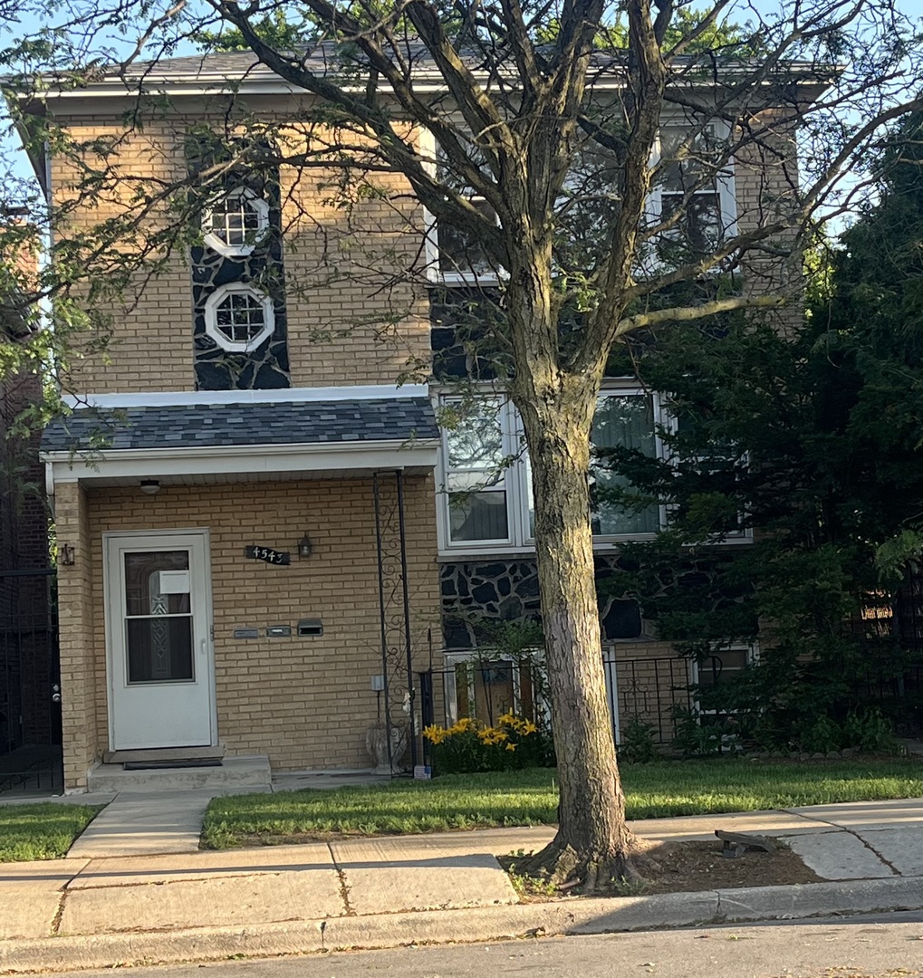 4543 West Marquette Road, Unit 2 Chicago, IL 60629 - Photo 1 of 12 a front view of a house with garden