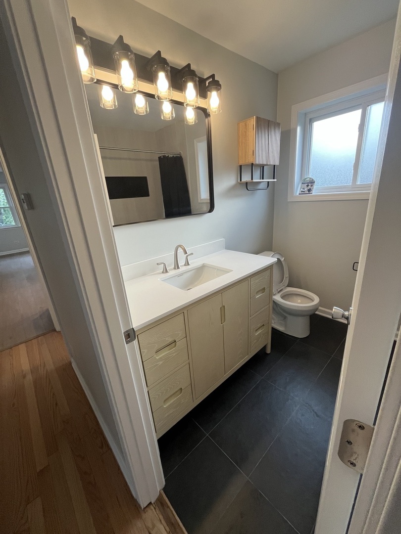 4543 West Marquette Road, Unit 2 Chicago, IL 60629 - Photo 11 of 12 a bathroom with a double vanity sink and a mirror