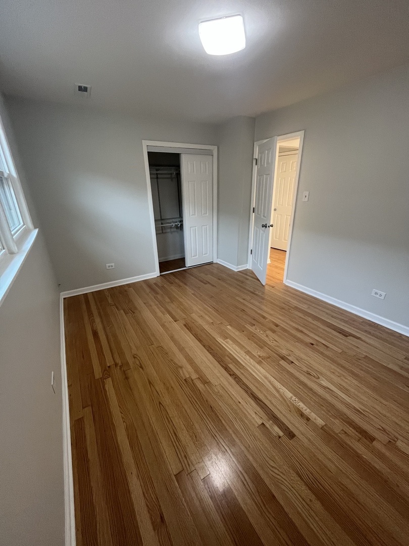 4543 West Marquette Road, Unit 2 Chicago, IL 60629 - Photo 4 of 12 a bedroom with a bed and a window