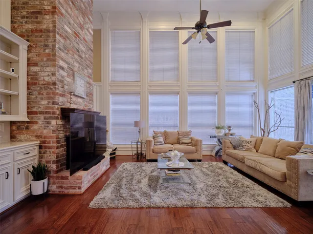 a view of a dining room with furniture a chandelier and wooden floor