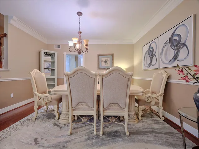 a view of a dining room with furniture and a chandelier