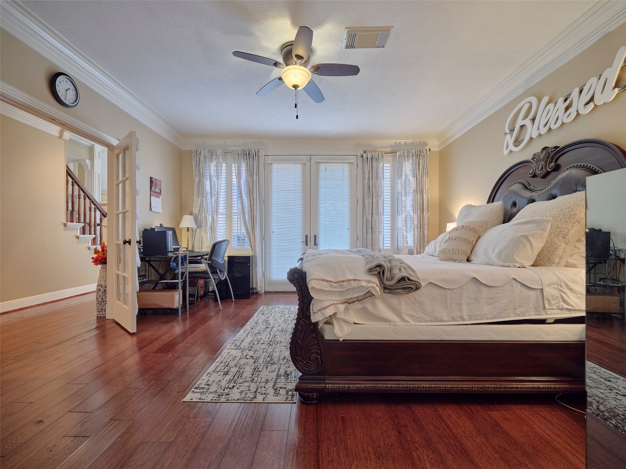 16623 Manningtree Lane Spring, TX 77379 - Photo 20 of 39 Spacious bedroom with elegant wood flooring, a decorative ceiling fan, ample natural light, and french doors. Warm, inviting atmosphere.