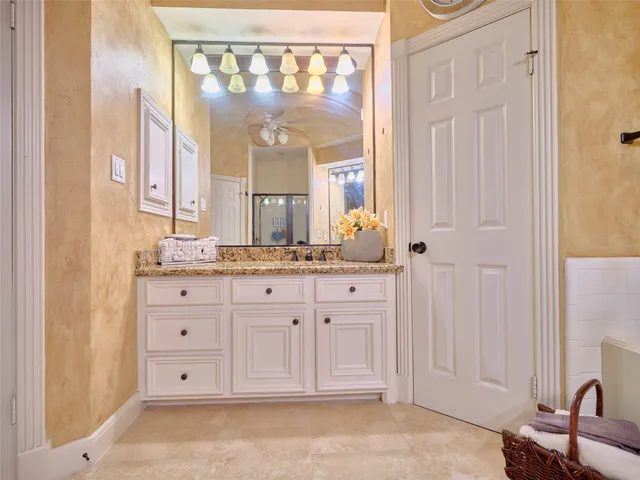 a spacious bathroom with a granite countertop sink a mirror and a