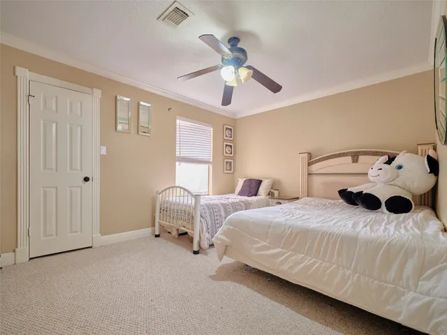 a bedroom with bed and a chandelier