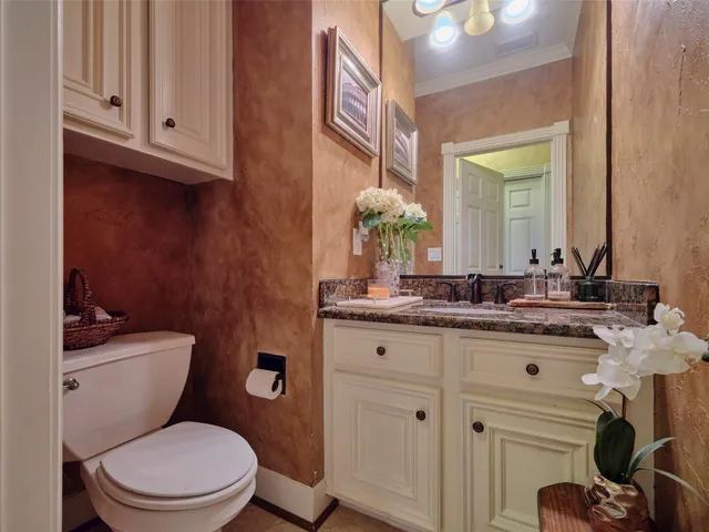 a view of a chair and table in backyard of the house