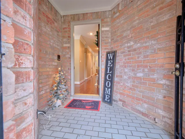 a view of entryway with livingroom and chandelier